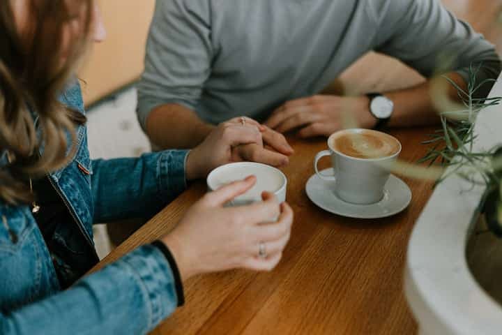 two-mugs-with-coffee-on-table-girl-boy-dating
