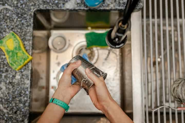 a-person-is-cleaning-a-sink-with-a-rag-household-chores