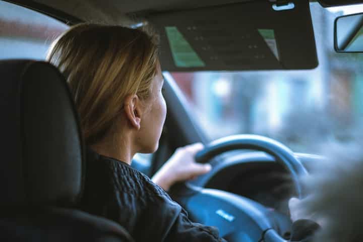 a-woman-sitting-in-a-car-with-a-steering-wheel-learn-driving