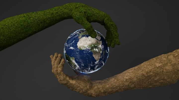 two-hands-are-holding-a-small-earth-globe carbon footprint save environment